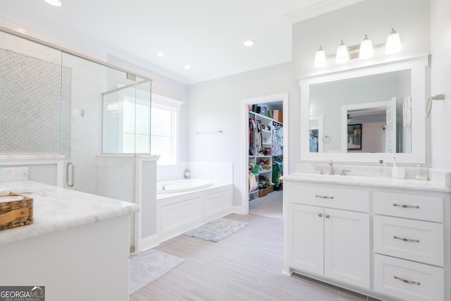 full bathroom with vanity, ornamental molding, a stall shower, and a spacious closet