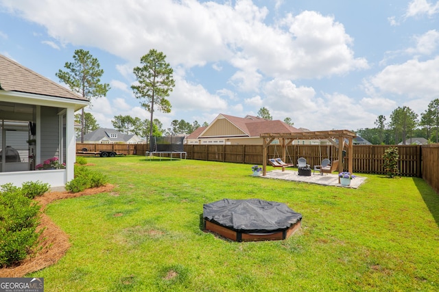 view of yard featuring a pergola, a fenced backyard, a patio area, a trampoline, and an outdoor fire pit