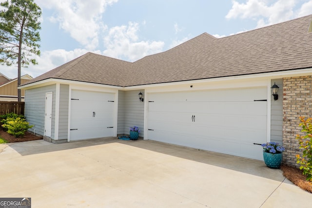 garage featuring concrete driveway
