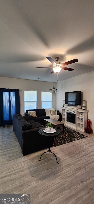 77 Willowrun Dr SW, Rome, GA 30165 - living room featuring a ceiling fan, wood finished floors, and a fireplace