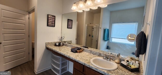 77 Willowrun Dr SW, Rome, GA 30165 - bathroom with vanity, baseboards, a stall shower, and wood finished floors