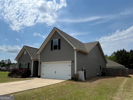 77 Willowrun Dr SW, Rome, GA 30165 - view of front of property featuring fence, an attached garage, concrete driveway, and a front lawn