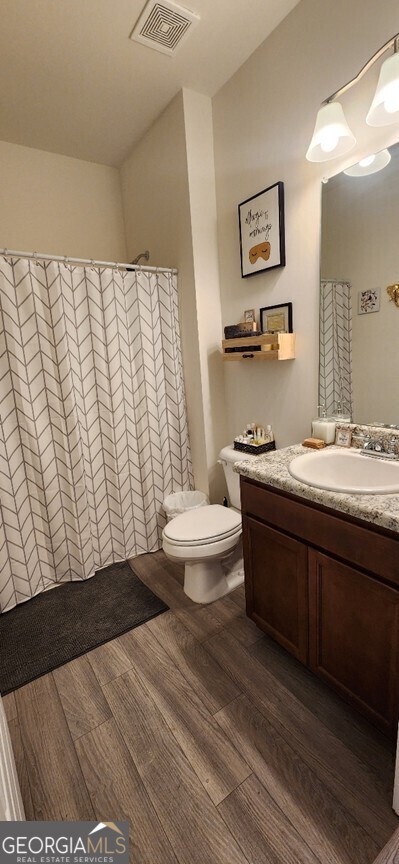 77 Willowrun Dr SW, Rome, GA 30165 - full bathroom with vanity, toilet, wood finished floors, and visible vents