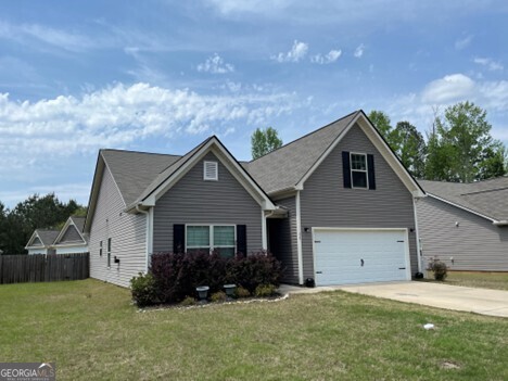 77 Willowrun Dr SW, Rome, GA 30165 - view of front of home with fence, driveway, a front yard, and a garage