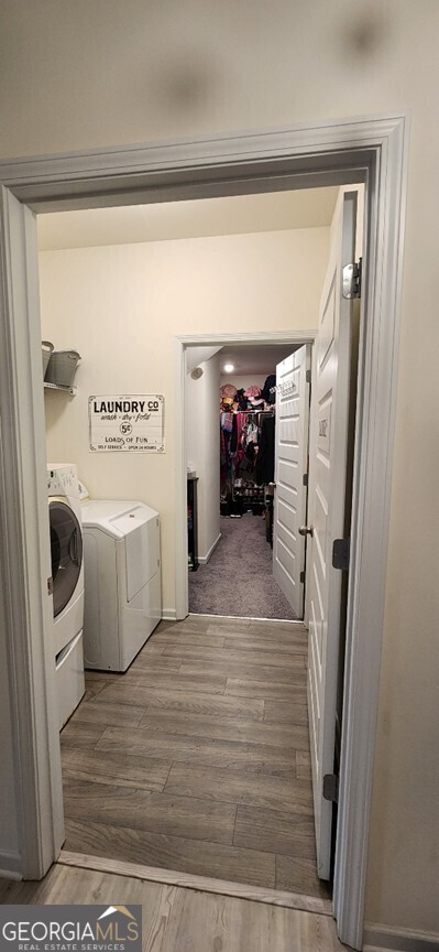 77 Willowrun Dr SW, Rome, GA 30165 - clothes washing area featuring baseboards, laundry area, washing machine and dryer, and wood finished floors