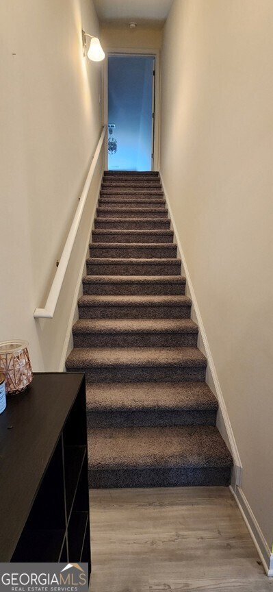 77 Willowrun Dr SW, Rome, GA 30165 - stairs with baseboards and wood finished floors