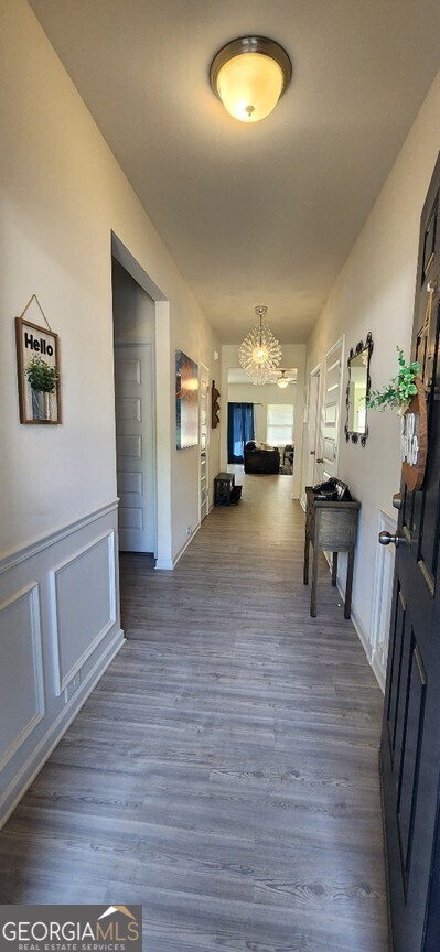 77 Willowrun Dr SW, Rome, GA 30165 - corridor featuring dark wood-type flooring and a chandelier