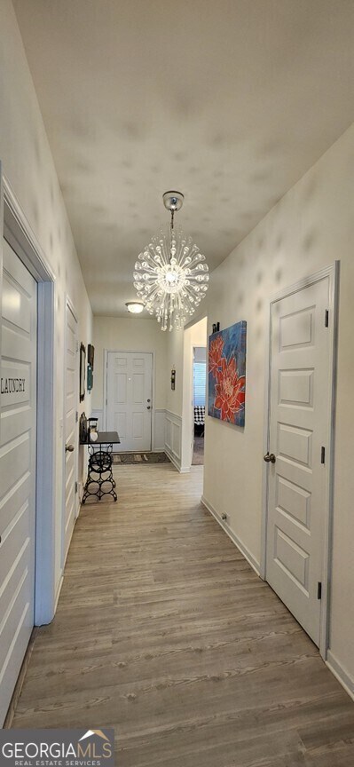 77 Willowrun Dr SW, Rome, GA 30165 - hallway featuring a notable chandelier and wood finished floors