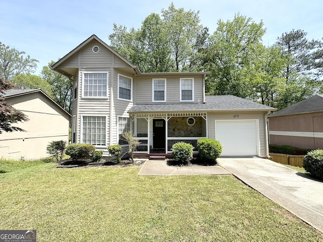 traditional-style house with a front lawn, an attached garage, a shingled roof, concrete driveway, and a porch