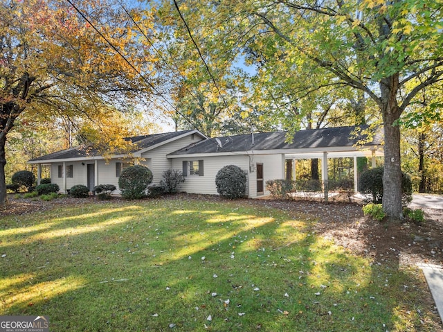 ranch-style home with driveway, a front yard, and a carport