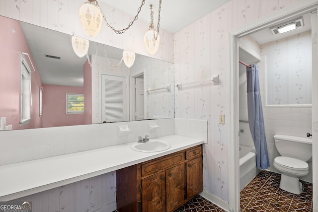 full bathroom featuring wallpapered walls, visible vents, and vanity