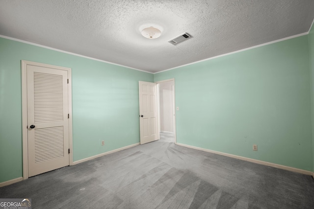 unfurnished bedroom featuring crown molding, a textured ceiling, visible vents, and baseboards