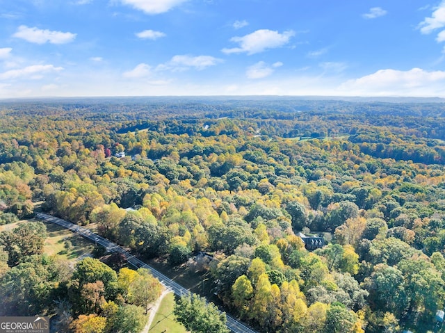 drone / aerial view featuring a forest view