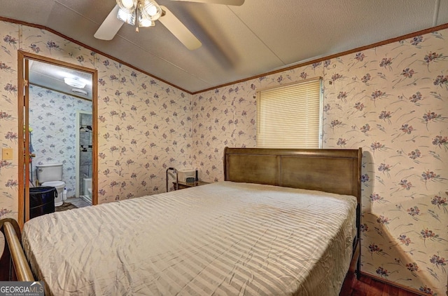 bedroom featuring ceiling fan, crown molding, wood finished floors, lofted ceiling, and wallpapered walls