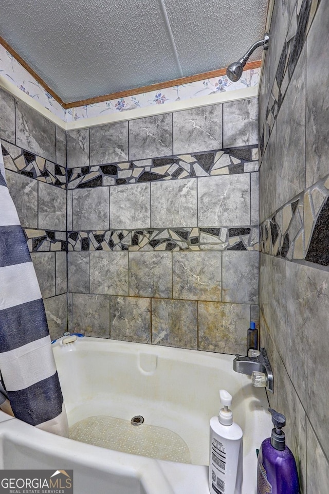bathroom with shower / bath combo and tile walls