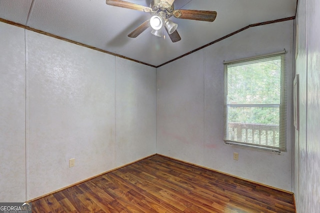 spare room featuring crown molding, a ceiling fan, vaulted ceiling, and wood finished floors