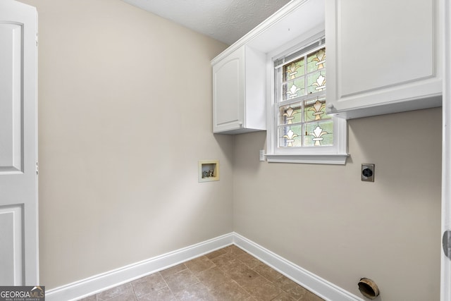 laundry area featuring baseboards, cabinet space, washer hookup, and electric dryer hookup