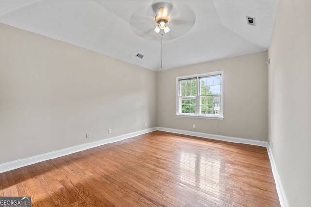 spare room with visible vents, a ceiling fan, and light wood finished floors