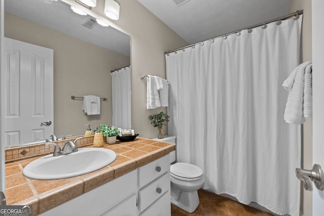 bathroom with vanity, tile patterned floors, visible vents, and toilet
