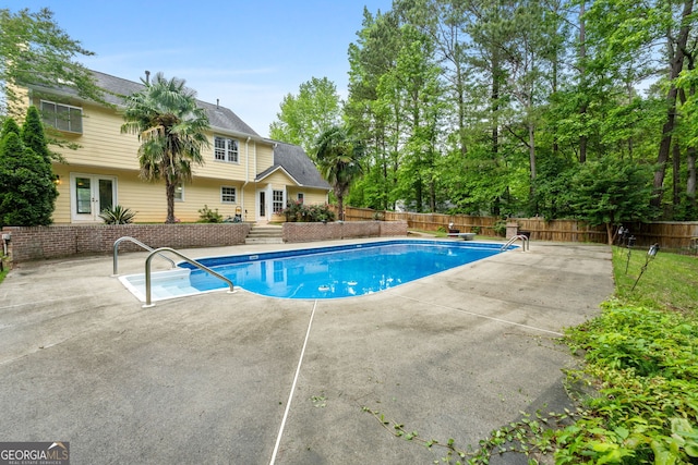 view of pool with a fenced backyard, a fenced in pool, french doors, and a patio