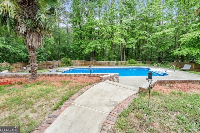view of swimming pool with a fenced in pool, a fenced backyard, and a patio