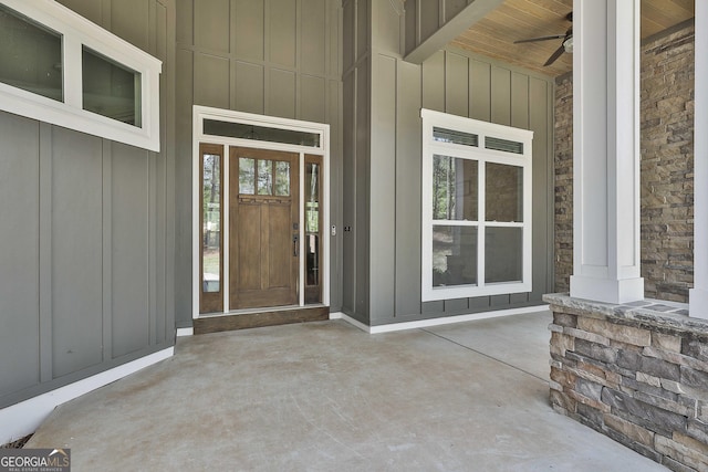 property entrance with a porch, ceiling fan, and board and batten siding