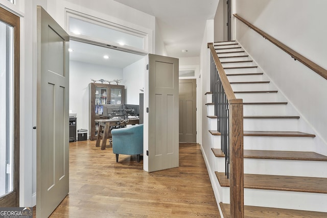 staircase featuring recessed lighting and wood finished floors