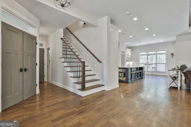 entrance foyer with stairway, baseboards, dark wood-style flooring, and recessed lighting