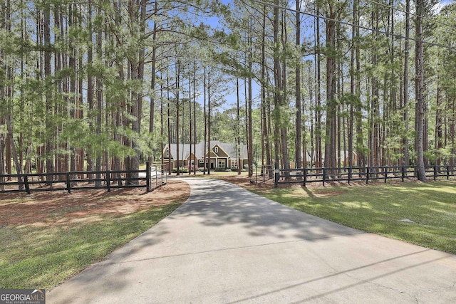 view of property's community with a yard and fence