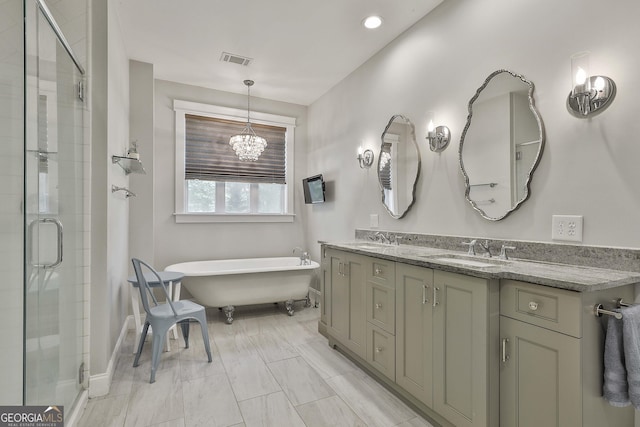 bathroom featuring double vanity, visible vents, a shower stall, and a sink
