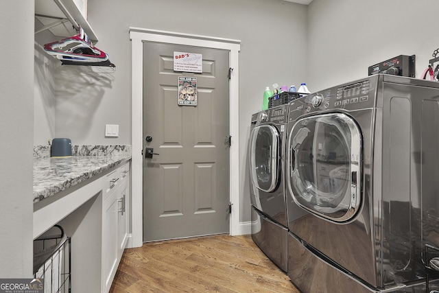 clothes washing area with light wood-style floors, laundry area, and independent washer and dryer