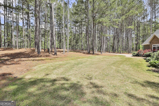 view of yard featuring a view of trees