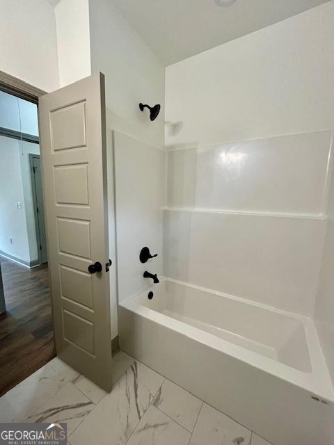 full bathroom featuring shower / bath combination and marble finish floor