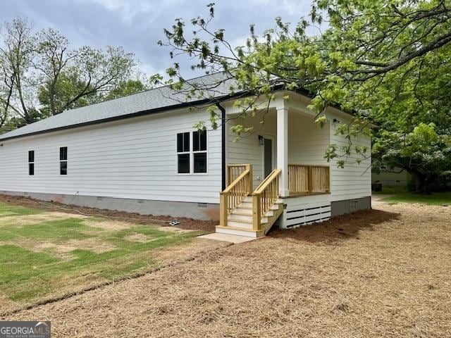 rear view of house with covered porch and crawl space