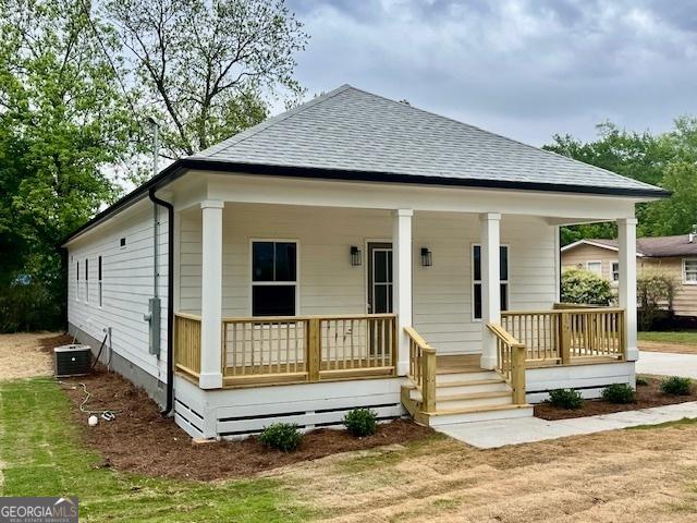 view of front of property with a porch and a shingled roof