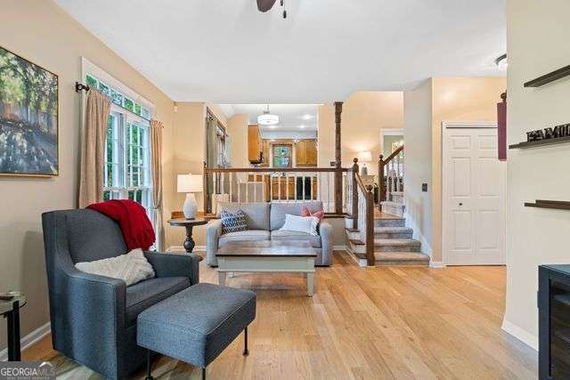 3376 Hickory Ln, Powder Springs, GA 30127 - living room with stairway, baseboards, a ceiling fan, and wood finished floors