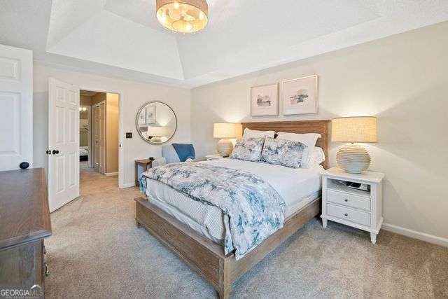 3376 Hickory Ln, Powder Springs, GA 30127 - bedroom with carpet floors, a tray ceiling, and baseboards