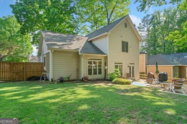 3376 Hickory Ln, Powder Springs, GA 30127 - back of property featuring a yard, fence, and a patio area