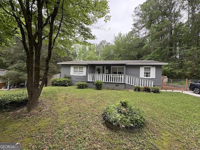view of front of house featuring fence, a front yard, a porch, and crawl space