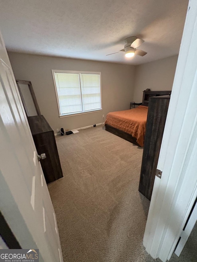 carpeted bedroom with baseboards and ceiling fan
