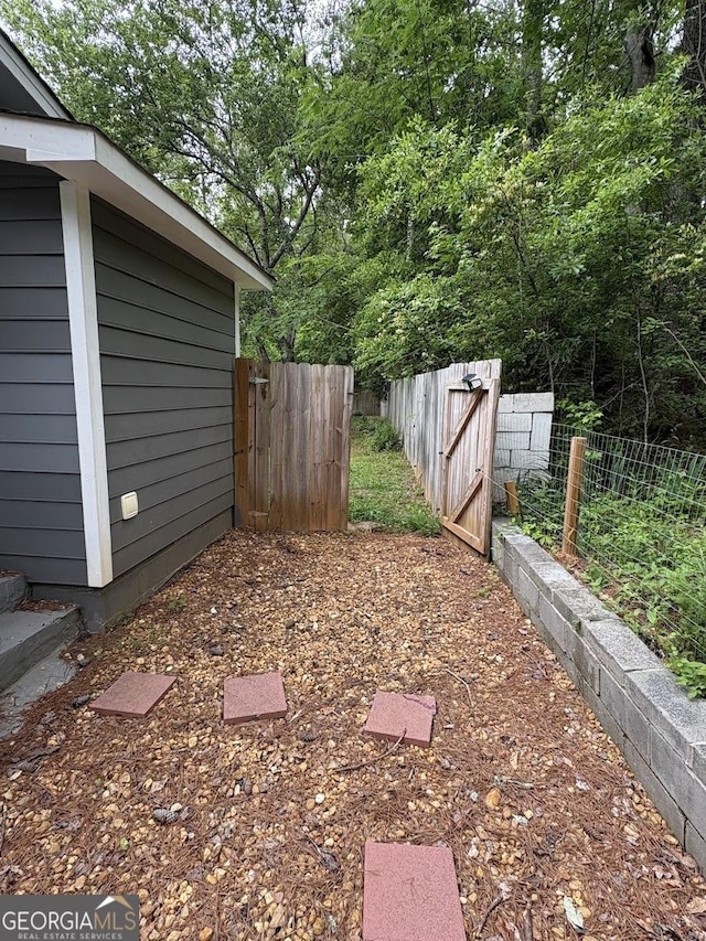 view of yard featuring fence and a gate