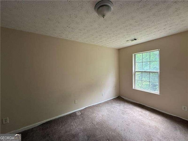 5280 Tussahaw Xing, Mcdonough, GA 30252 - empty room featuring baseboards, carpet, a textured ceiling, and visible vents