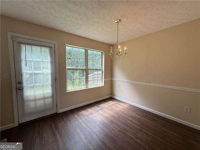5280 Tussahaw Xing, Mcdonough, GA 30252 - interior space featuring a textured ceiling, baseboards, a notable chandelier, and wood finished floors