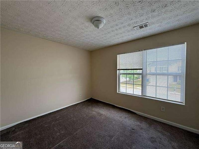 5280 Tussahaw Xing, Mcdonough, GA 30252 - empty room with baseboards, dark carpet, a textured ceiling, and visible vents