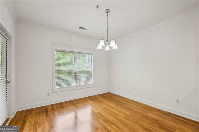 655 Mead St SE Unit 58, Atlanta, GA 30312 - spare room with a chandelier, light wood-style flooring, baseboards, and crown molding