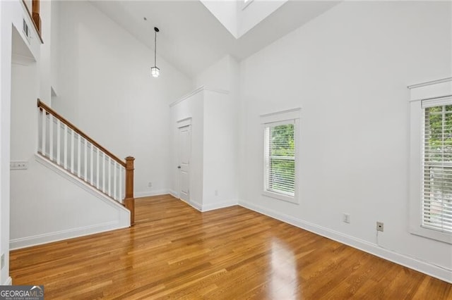 655 Mead St SE Unit 58, Atlanta, GA 30312 - foyer featuring wood finished floors, high vaulted ceiling, stairs, and baseboards