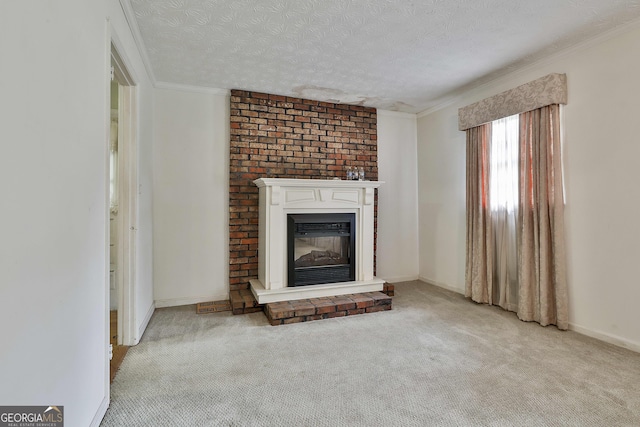 unfurnished living room featuring a textured ceiling, crown molding, baseboards, a glass covered fireplace, and carpet flooring