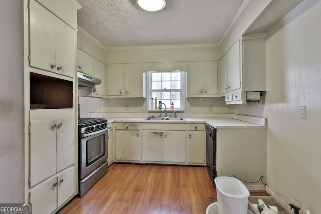 kitchen featuring stainless steel gas range, a sink, light countertops, light wood-type flooring, and under cabinet range hood