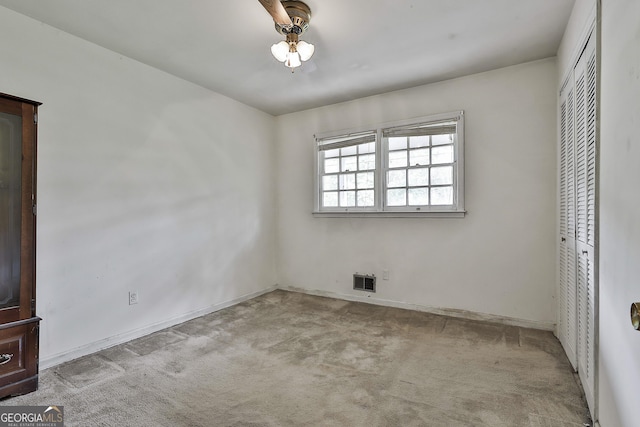 unfurnished bedroom with a closet, carpet, baseboards, and visible vents