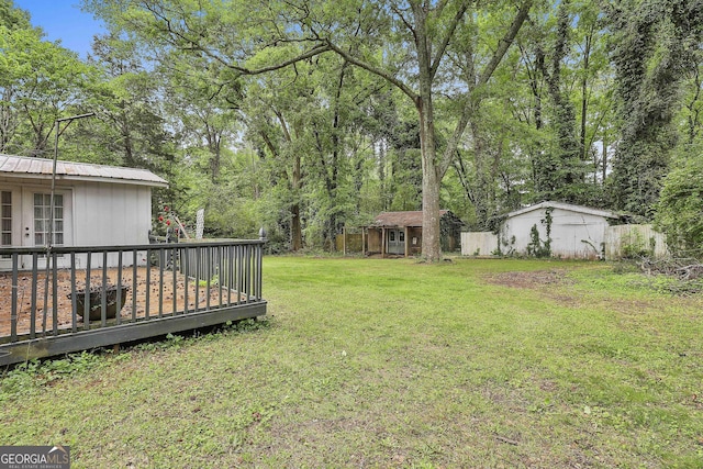 view of yard featuring an outdoor structure and french doors